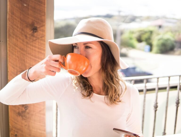 A woman enjoying a warm drink outdoors with a summer vibe. Perfect for lifestyle and relaxation themes.